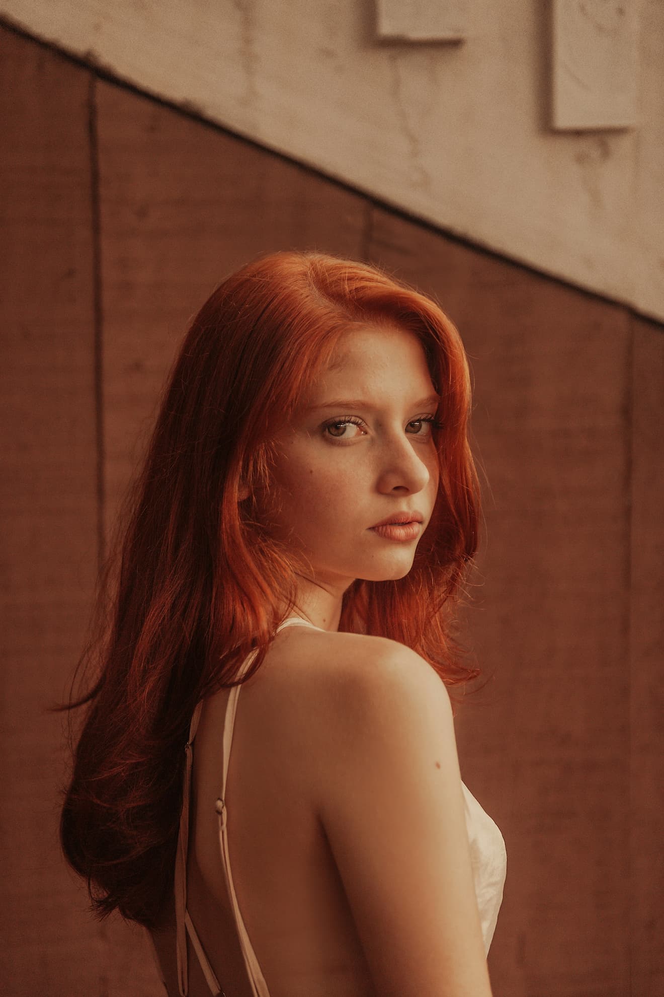 Woman looking over her shoulder against urban backdrop